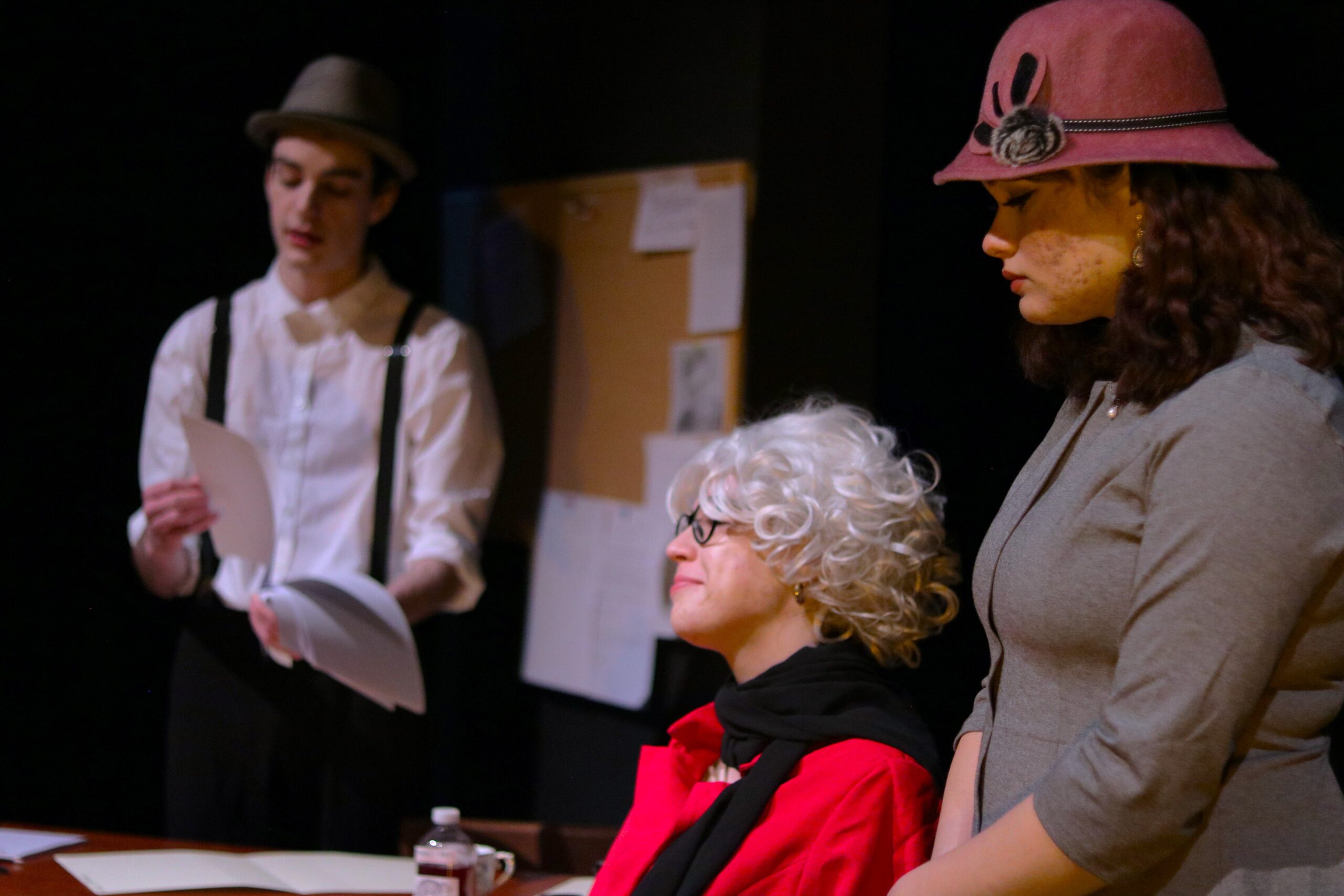 Detective-Sergeant Fergusson interrogating Mrs. Caroline Grills (Livvy Brooks), assisted by Policewoman Margaret Fisher (Nadia Thivy).