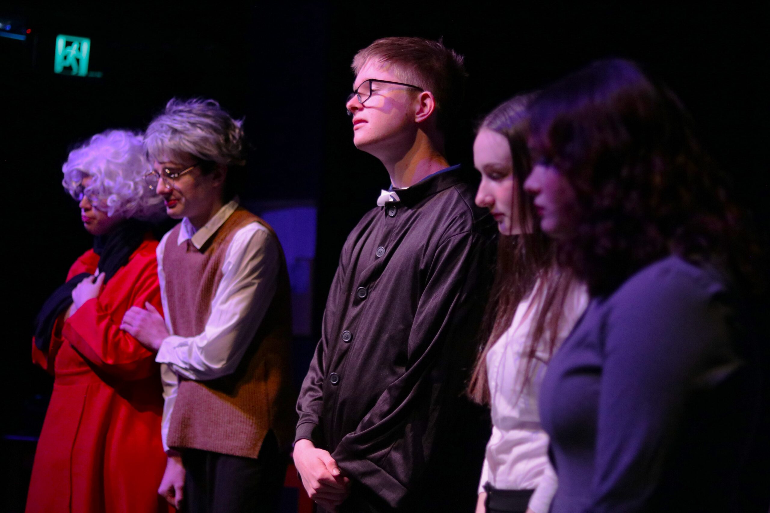 The Priest (Conor McLauchlan) presiding over Mary Ann Mickelson's funeral, while the Mickelsons (Nadia Thivy and Maddie Cruickshank), Mr. Richard Grills (me) and Mrs. Caroline Grills (Livvy Brooks) mourn.